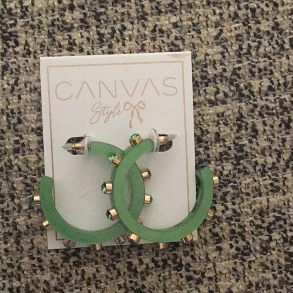 Emerald green,  pierced ears,sptiked with emerald stones.